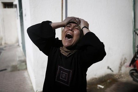 Woman who lost her family (imemc.org - image by Amnesty International)