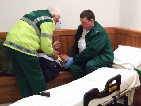 Click on image to see full-sized version Paramedics deal with Niall in the foyer of the court