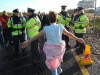 Mary showing her bruising to those who assaulted her.