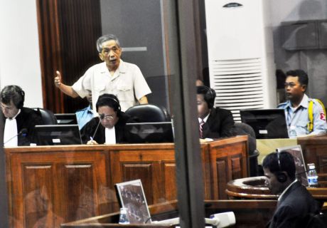 Click on image to see full-sized version src WikiMedia Commons. Kang Kek Iew (also Kaing Guek Eav or Duch) before the Extraordinary Chambers in the Courts of Cambodia. He was responding to the testimony given by his former subordinate Him Huy who was a Khmer Rouge prison guard.